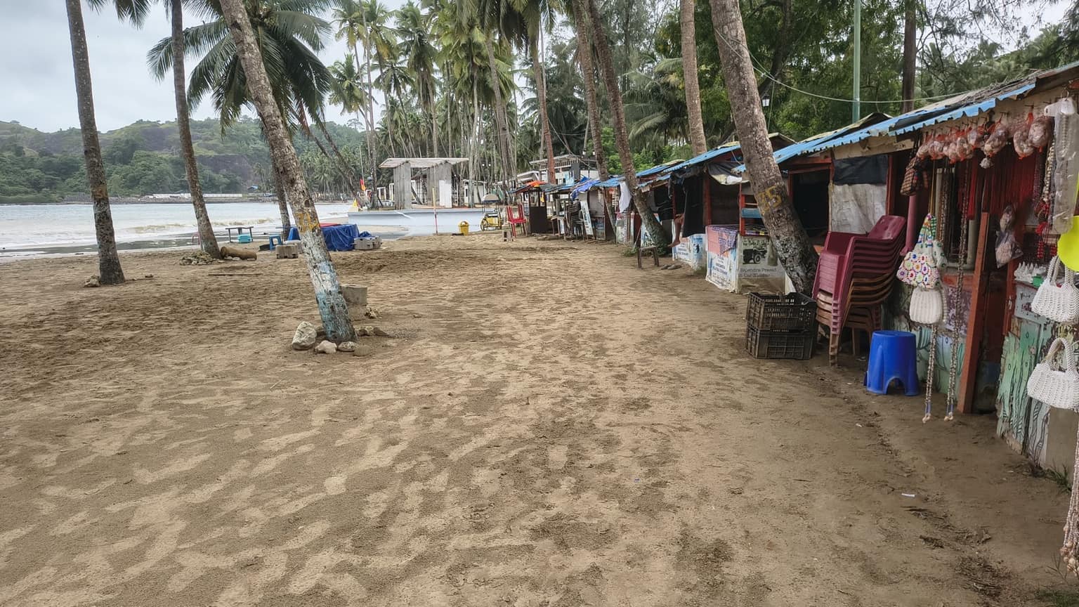 Palm-lined sand and beach shacks at Corbyn's Cove, Port Blair