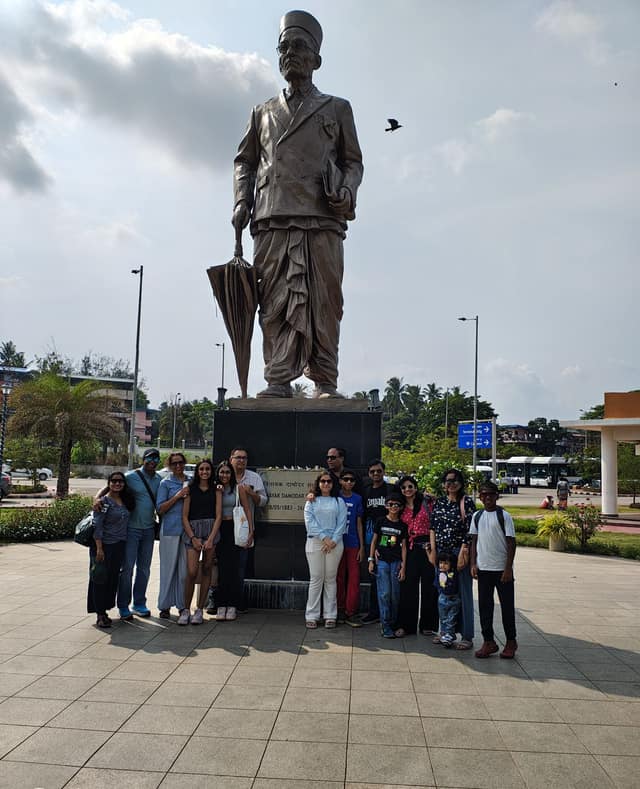 An extended family group at the Veer Savarkar statue, Port Blair airport plaza