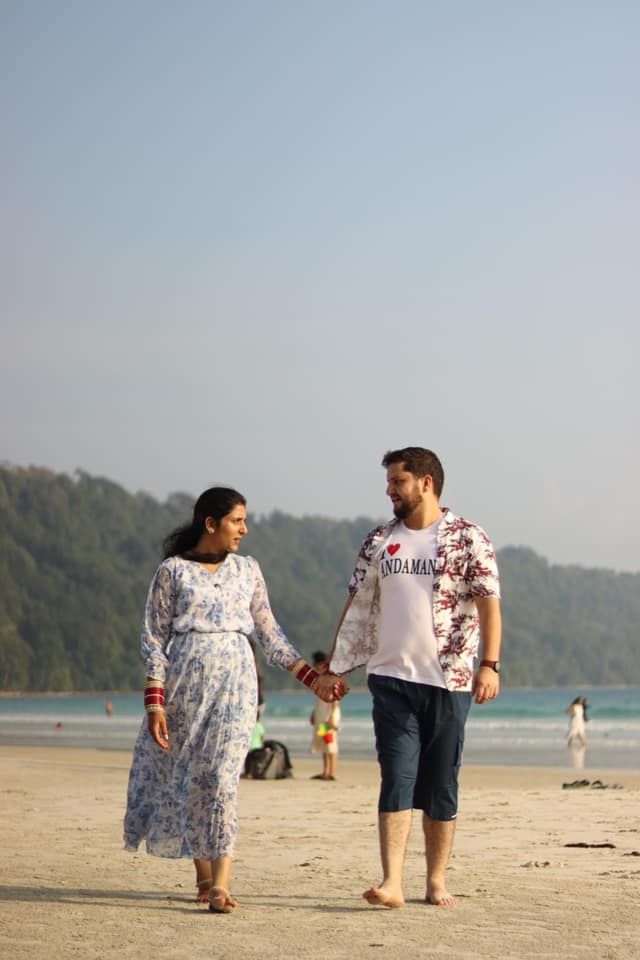A couple walking the beach during their photoshoot in the Andamans