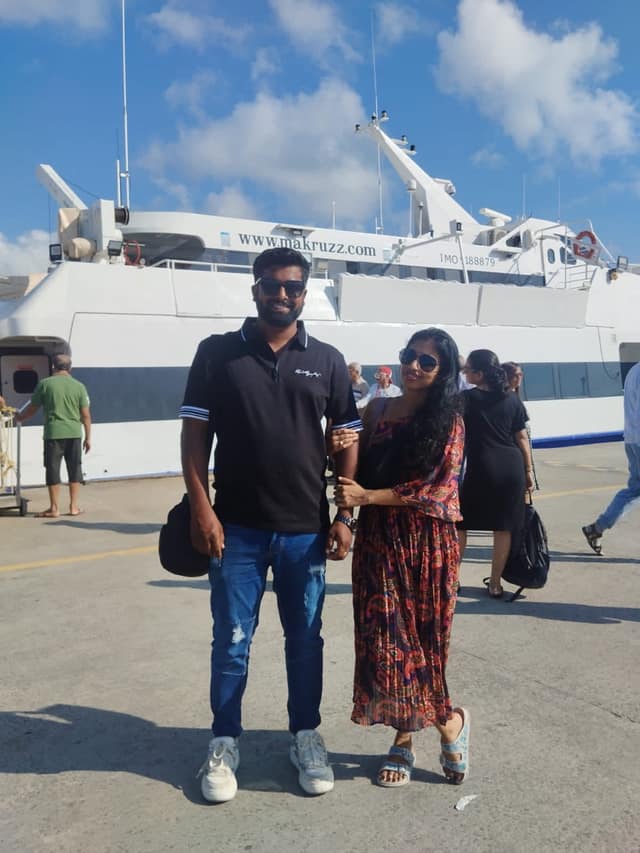 A couple at the Port Blair jetty in front of a Makruzz inter-island ferry
