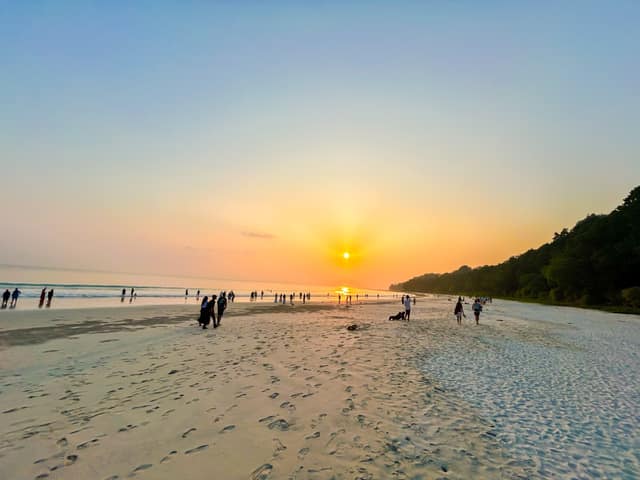 Sunset crowd at the waterline of Radhanagar Beach