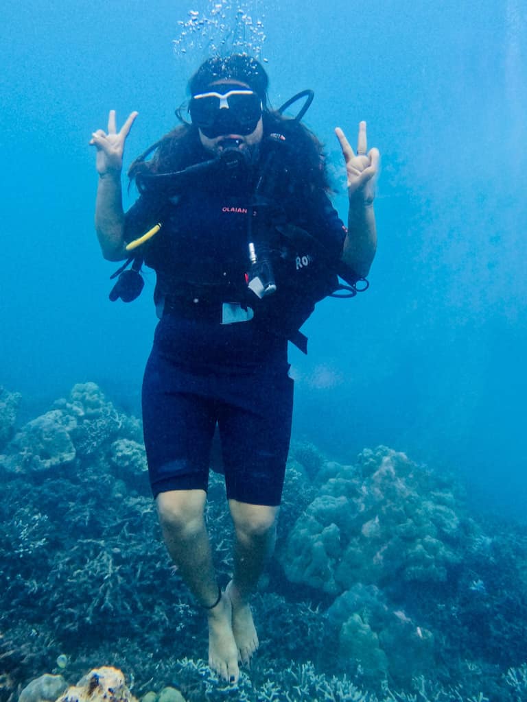Scuba diver over a coral reef in the Andamans